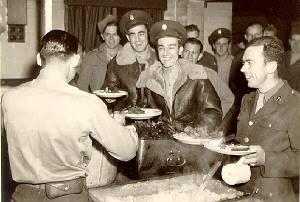 Servicemen at the Hethel air base being served a meal.